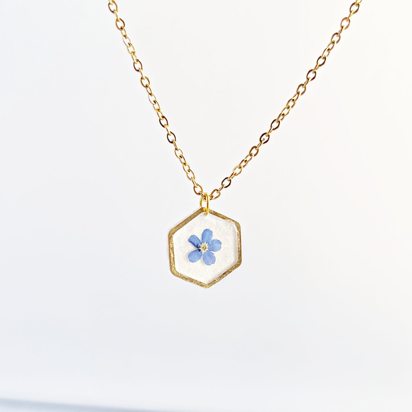 Small blue forget-me-not flower in resin necklace for women flower in hexagonal gold pendants Minimalist jewelry gifts for her