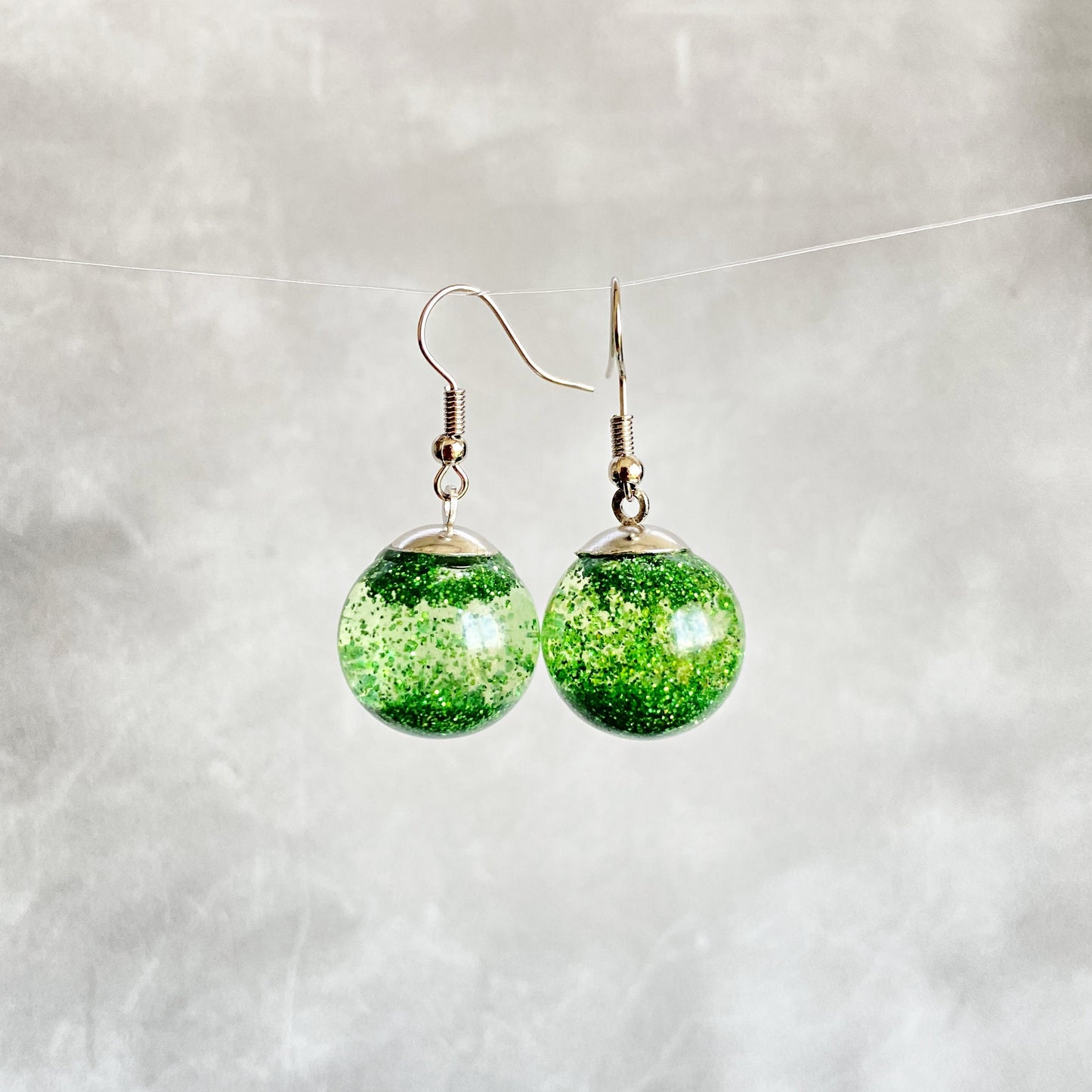 Green sequins floating in a glass bottle earrings Snow globe jewelry Glass globe flying snowflakes winter jewelry Christmas gift for women