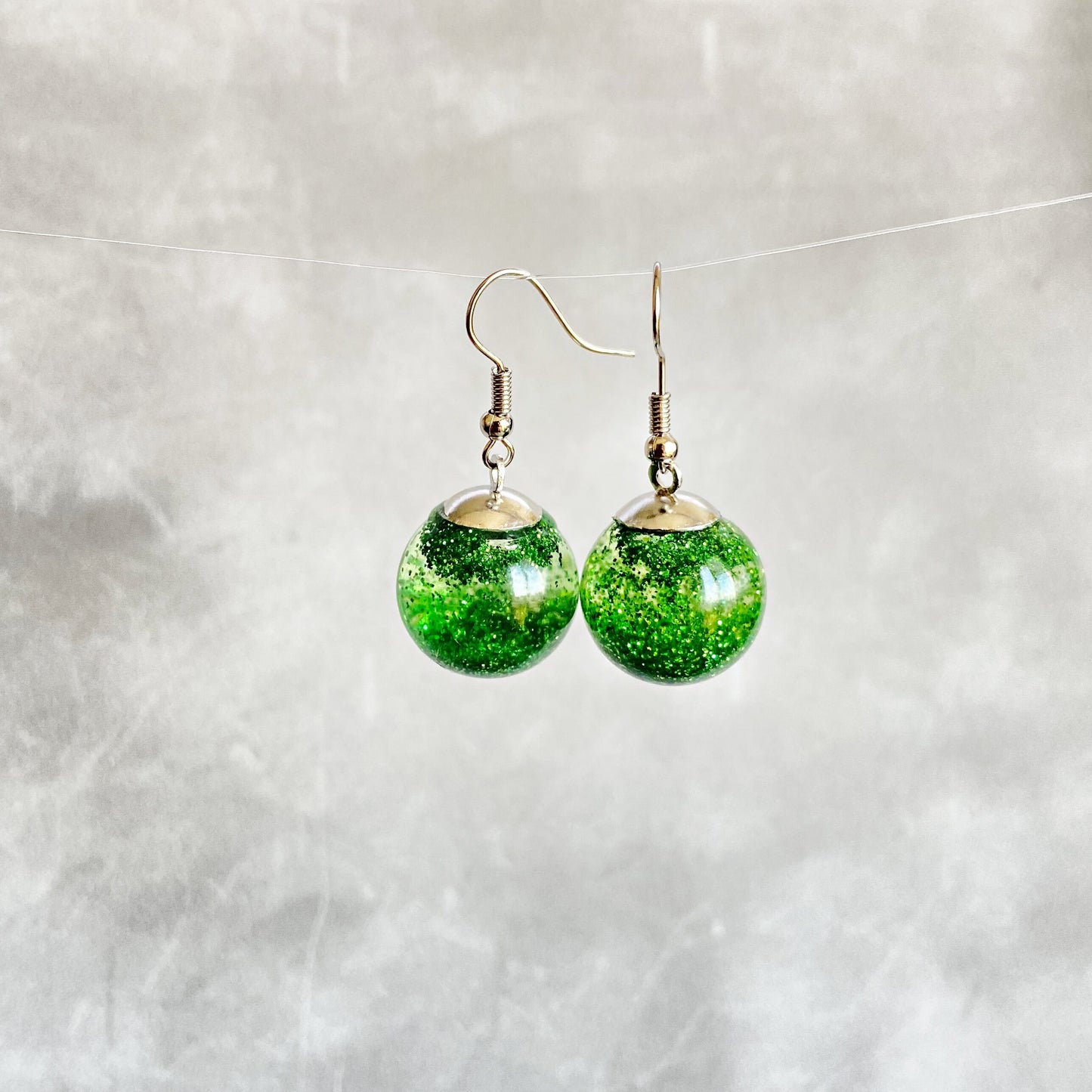 Green sequins floating in a glass bottle earrings Snow globe jewelry Glass globe flying snowflakes winter jewelry Christmas gift for women