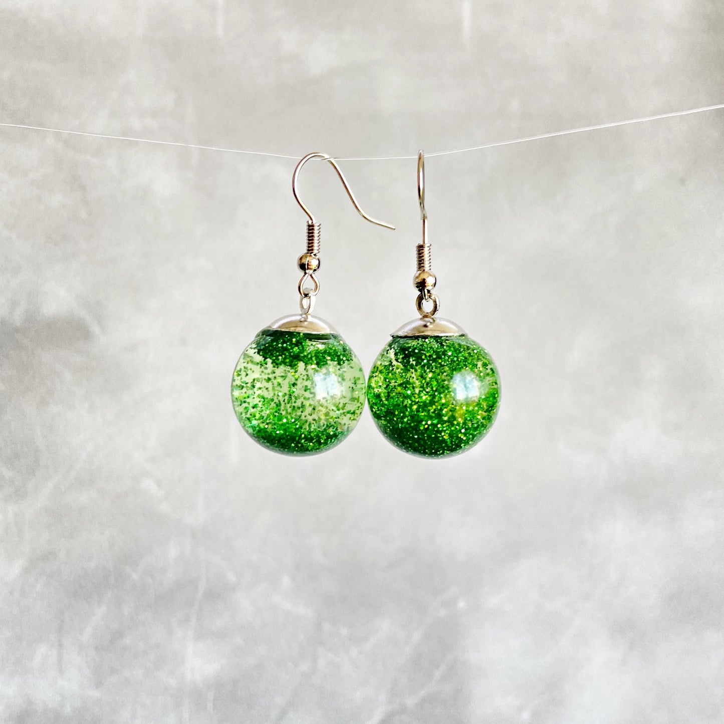Green sequins floating in a glass bottle earrings Snow globe jewelry Glass globe flying snowflakes winter jewelry Christmas gift for women