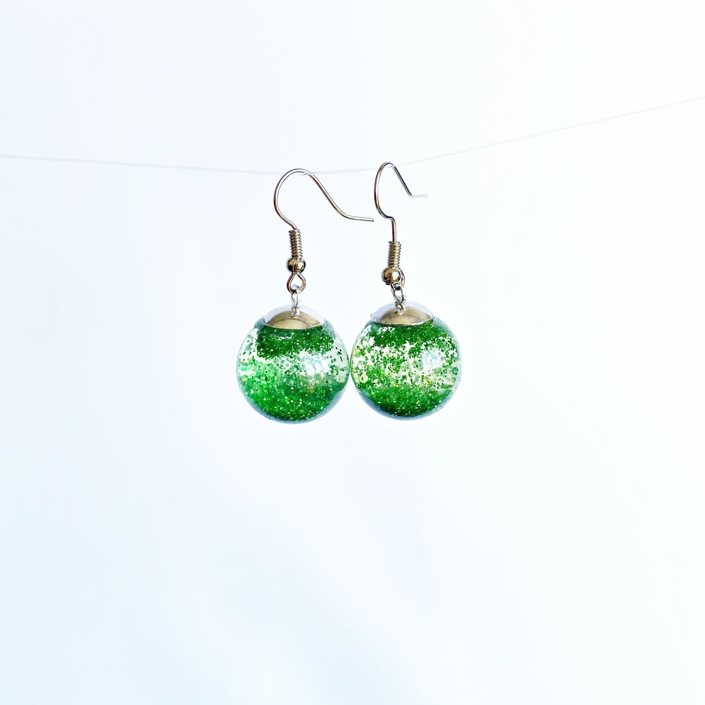 Green sequins floating in a glass bottle earrings Snow globe jewelry Glass globe flying snowflakes winter jewelry Christmas gift for women